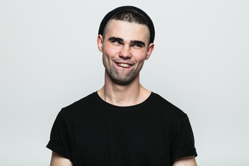Obraz premium Studio portrait of adult man making smiling face on white background.