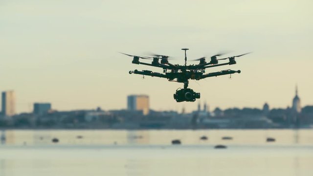 Six Rotor Drone with Camera on Gimbal flying in the Sky. Shot in Slow motion. 