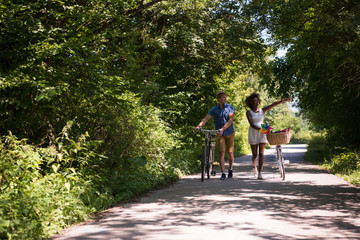 Fototapeta premium Young multiethnic couple having a bike ride in nature