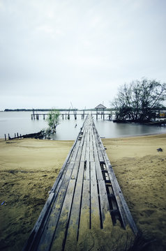 wooden jetty and dramatic clouds.soft focus and blurred image due to long exposure shot.