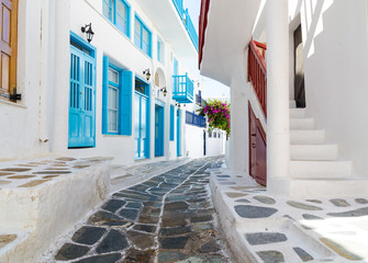 whitewashed narrow street in Mykonos island, Cyclades, Greece © lukaszimilena