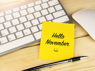 Hello November on sticky note on work table