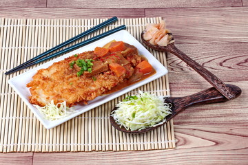 Deep fried dolly fish (Crispy) in Japanese style topped yellow curry with side dish as sliced cabbage and pickled ginger are very delicious