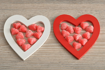 Naklejka na ściany i meble Valentine's Day. Wooden heart filled with sugar heart candy