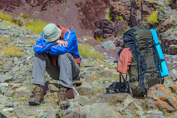 Trekker resting in height mountain