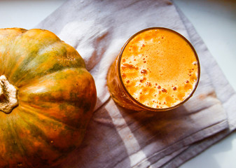 fresh pumpkin juice with punpkin on the table