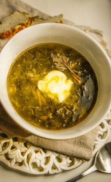 Delicious soup or green borch with spinach, served in white bowl