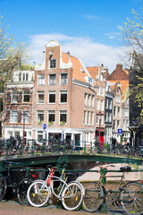 Houses and bicycles standing next to canal in Amsterdam, Netherlands