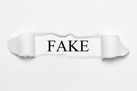 Fake on white torn paper