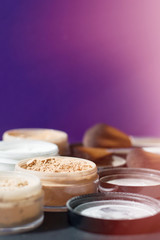 Vertical photo of make up mineral powder of beige and white color. Beauty kit