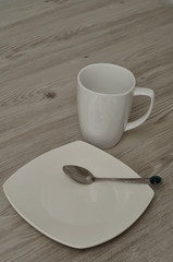 Mug and saucer and a spoon