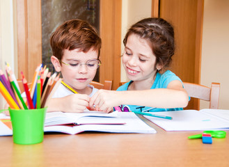 Elder sister helping her brother with his homework