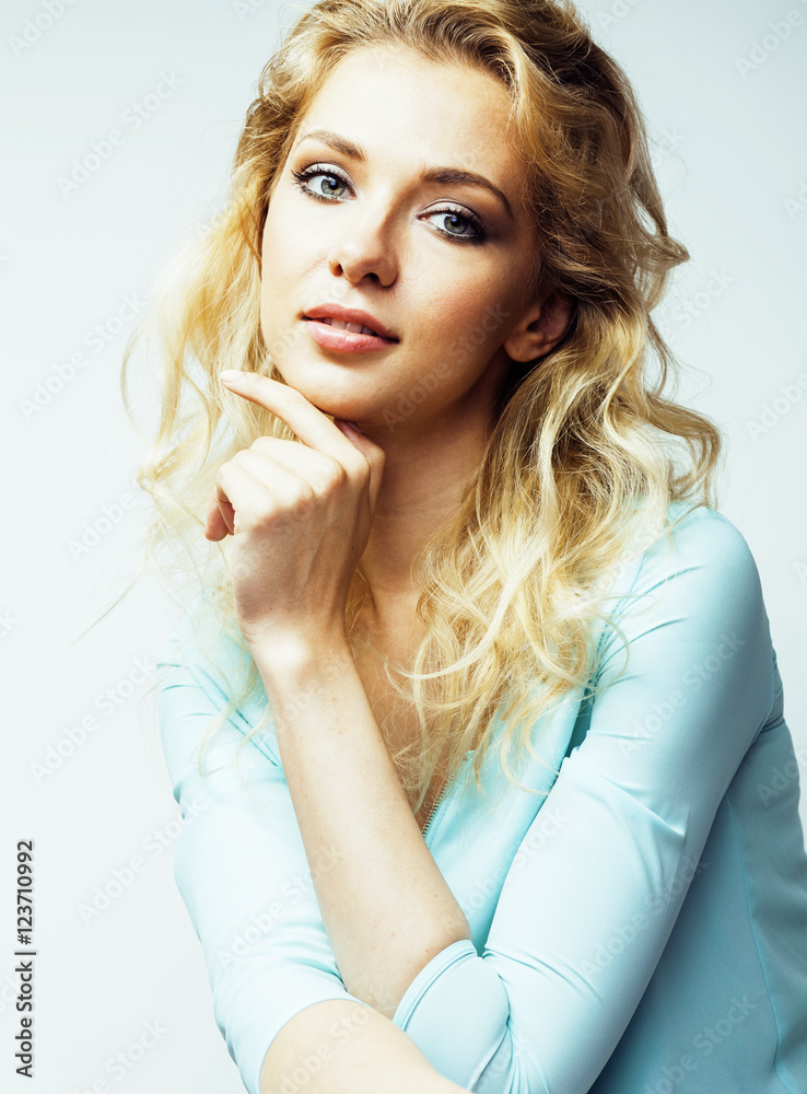 Wall mural young pretty blond woman smiling on white background close up ma