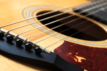 acoustic guitar detail of the bridge and of the saddle