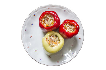 Varicolored stuffed peppers with rice and meat on a white plate.	The site of the traditional and healthy cuisine, cooking, vegetables.	