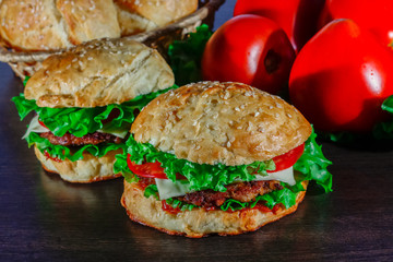 Close-up of home made tasty burgers on wooden table