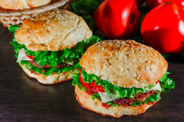 Close-up of home made tasty burgers on wooden table