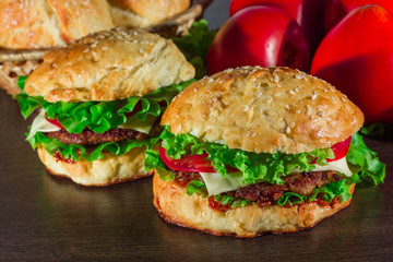 Close-up of home made tasty burgers on wooden table