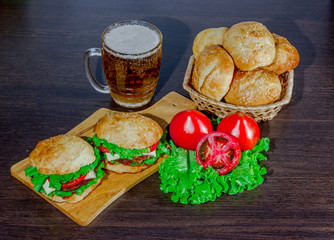beer and homemade burgers buns with beef patties  fresh salad ingredients