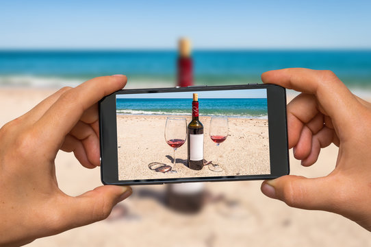 Taking photo of wine and glasses with mobile phone