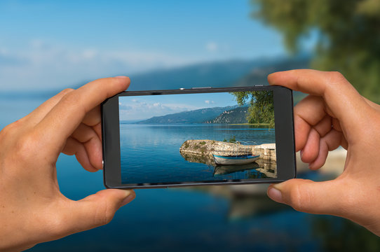 Taking photo of Ohrid lake in Macedonia with mobile phone
