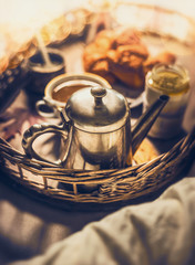 Early breakfast in bed: vintage coffee pot, Cup of coffee and croissants, close up, selective focus