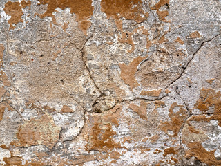 Old wall covered with paint plaster cracks