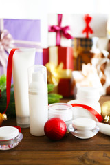 Beauty cosmetic products with Christmas decoration on blurred gifts background