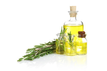 Bottles of coniferous essential oil and rosemary branch isolated on white