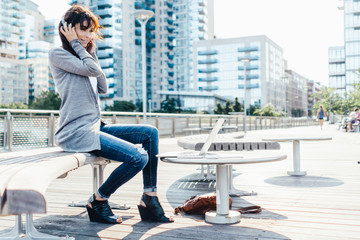 Young Woman Listening Music with Headphones and Mobile Phone  . New York City US