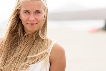 girl with blue eyes and blonde hair at the beach. clean skin. fresh look
