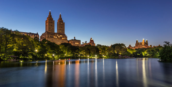 Central Park at twilight with The Lake and illuminated pathway and gazebos. Upper West Side, Manhattan, New York City