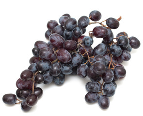 Black seedless grapes on a white background