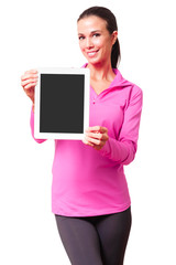 Fit young woman in sports clothing showing digital tablet computer isolated on white background