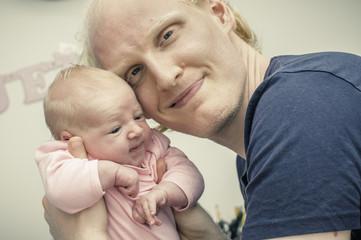 Father and newborn baby bonding portrait
