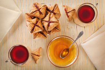 Two cups of tea, shortcake with jam and honey