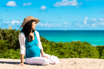 Fototapeta na wymiar Pregnant woman lying on beach