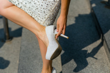 A close-up of a broken bride's shoe