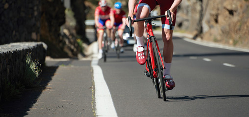 Naklejka na ściany i meble Cyclist athletes riding a race at high speed