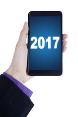 Hand with mobile phone and 2017