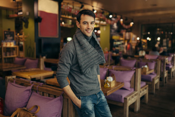 Fototapeta na wymiar Young handsome man standing and posing in the restaurant