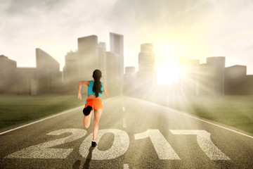 Woman running at street with 2017