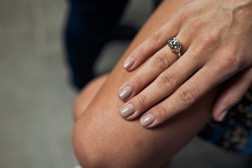 Old-fashioned engagement ring on delicate woman's hand