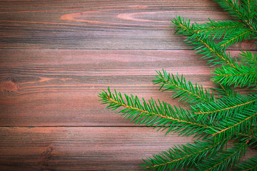 Christmas tree branch on a wooden background