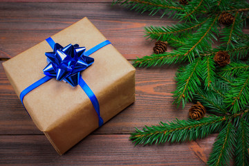Fototapeta na wymiar Christmas tree branch gifts on wooden background