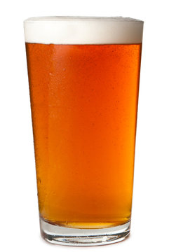 Foamy head pint glass of amber beer ale lager isolated on white background