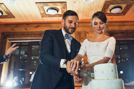 Happy Just Married Couple Cuts Pretty Wedding Cake