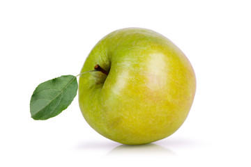 green apple with leaf lying on its side on a white background