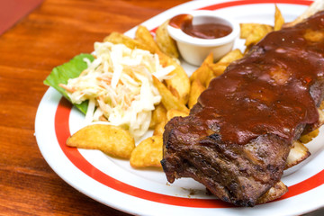 Grilled steak - Grilled meat ribs on the plate with hot sauce