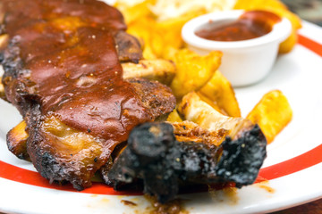 Grilled steak - Grilled meat ribs on the plate with hot sauce